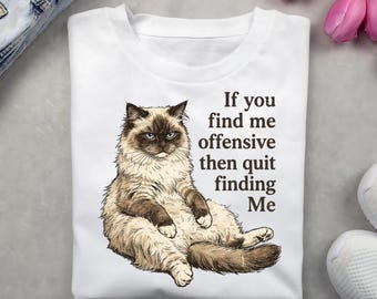 May include: White t-shirt featuring a detailed illustration of a fluffy cat with blue eyes. The text on the shirt reads, "If you find me offensive then quit finding Me."