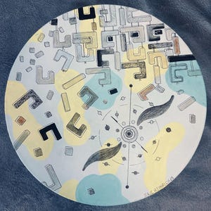 May include: Round, hand-painted artwork with an abstract design. The artwork features geometric shapes in black, gray, yellow, and blue on a white background. The artist's signature is visible in the lower right corner.