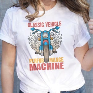 May include: White t-shirt with a blue motorcycle graphic and the text "Classic Vehicle Performance Machine".
