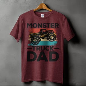 a red monster truck dad shirt hanging on a wall