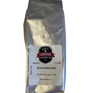 May include: A silver bag of Sumatra Black Satin coffee from Seagull Coffee in Edmonds, WA. The bag is labeled with the company name, location, and product information. The bag is 16 ounces (454 grams) and is a drip grind.
