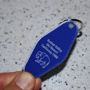 May include: Blue plastic key chain with a white outline of a bison and the text "Kodiak Valley Ski Resort California 1986"
