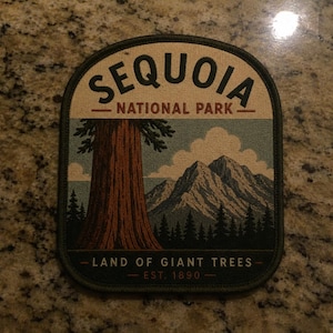 May include: A rectangular embroidered patch with rounded top corners featuring a landscape of Sequoia National Park. The text reads SEQUOIA NATIONAL PARK at the top and LAND OF GIANT TREES EST. 1890 at the bottom, with a large tree and mountains.