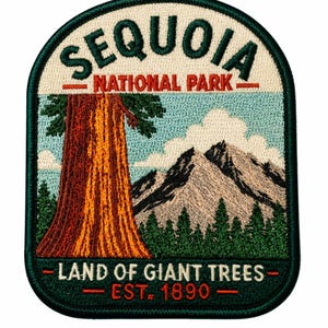 May include: An embroidered patch featuring a large sequoia tree, a mountain range, and clouds. The text reads SEQUOIA NATIONAL PARK at the top and LAND OF GIANT TREES EST. 1890 at the bottom. The patch has a dark green border and a light blue sky.