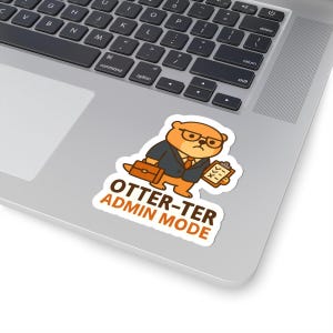 May include: A sticker showing a cartoon otter in a suit, glasses, and carrying a briefcase and clipboard. The text on the sticker reads "OTTER-TER ADMIN MODE" in brown and orange.