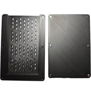 May include: Two-piece black plastic enclosure. One piece has a grid of rectangular perforations. The other piece is solid with a textured surface. Both pieces have mounting holes.