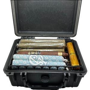 May include: A black hard-sided case with a latch and a handle. The case is open and contains several cigars, including some with the label "A. Fuente".