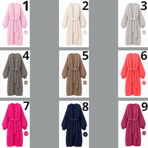 May include: A collection of nine long-sleeved, open-front knit cardigans, each featuring a matching tie belt at the waist and ribbed cuffs. The cardigans are displayed in various solid colors including pink, cream, gray, charcoal, brown, coral, magenta, navy, and plum.