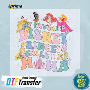 May include: A light blue t-shirt with a colorful graphic design featuring Disney princesses and the text "My Favorite Disney Princess Calls Me Mama".