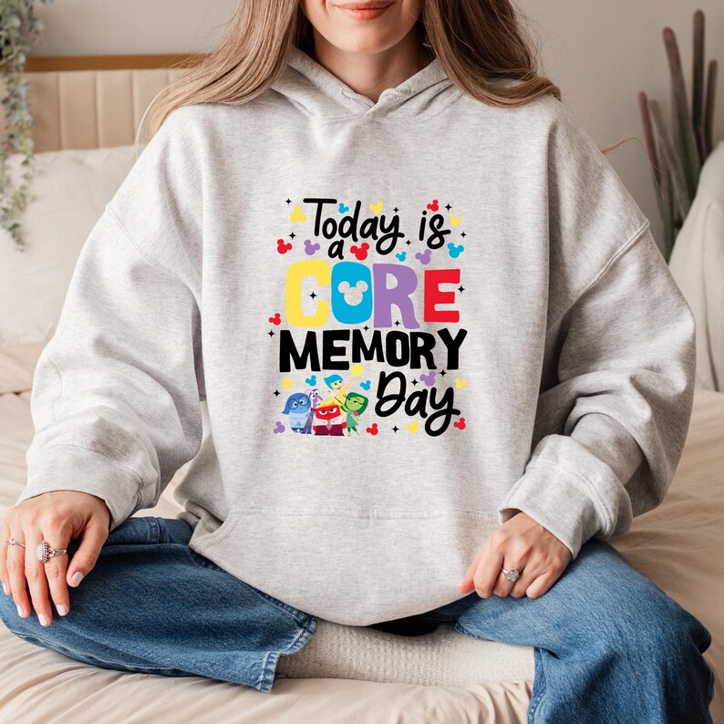 May include: Gray hoodie with a graphic print of the characters from the movie Inside Out. The text on the hoodie reads "Today is a CORE MEMORY Day".