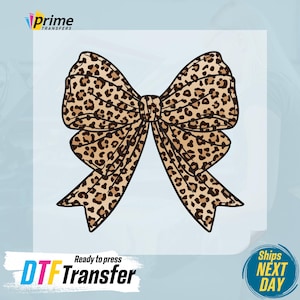May include: A brown and tan leopard print bow tie. The bow tie is a DTF transfer, ready to press.