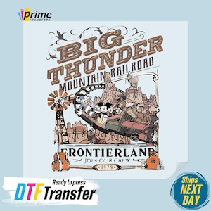 May include: A DTF transfer featuring a vintage-style design of the Big Thunder Mountain Railroad ride. The design includes the text "Big Thunder Mountain Railroad" and "Frontierland", with cartoon characters riding a train. The transfer is ready to press.