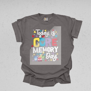 May include: Gray t-shirt with a graphic print of the characters from the movie Inside Out. The text on the shirt reads "Today is a CORE MEMORY Day."