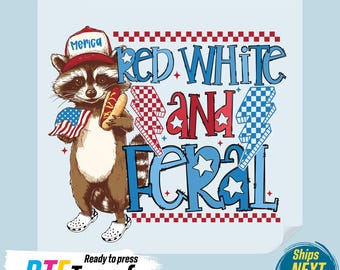 May include: A DTF transfer featuring a raccoon wearing a hat with "Merica" on it, holding a hot dog and an American flag. The text "Red White and Feral" is displayed in red and blue. The transfer is ready to press.