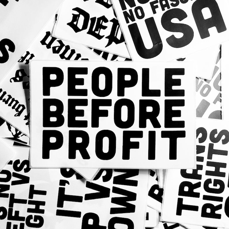 May include: Black and white text on a white background. The text reads "People Before Profit".
