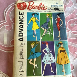 May include: A vintage Advance sewing pattern envelope for Barbie teen age fashion doll clothes. The front features six illustrations of dolls wearing various outfits, including dresses and a coat, with the text Barbie, 6 Patterns, and Advance.