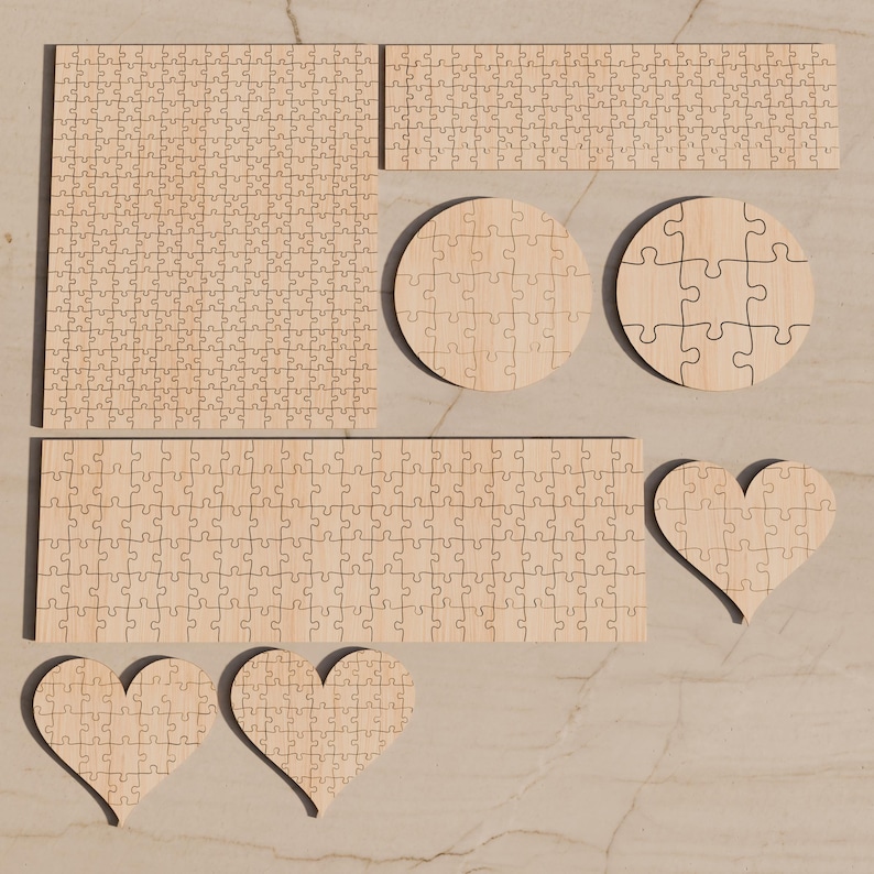 May include: A collection of unfinished light wood jigsaw puzzles in various shapes, including one large square, one long rectangle, one shorter rectangle, two circles, and three heart shapes, all featuring interlocking puzzle piece cutouts.