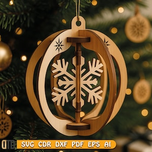 May include: Wooden Christmas ornament with a snowflake design. The ornament is made of light and dark brown wood, with a snowflake in the center. The ornament is hanging from a gold string. The text "SVG CDR DXF PDF EPS AI" is at the bottom.