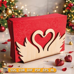 May include: A red napkin holder with a wooden swan design. The holder is filled with red napkins with a floral pattern. The base of the holder is brown. The image also includes Christmas ornaments and the text "SVG CDR DXF PDF EPS AI".