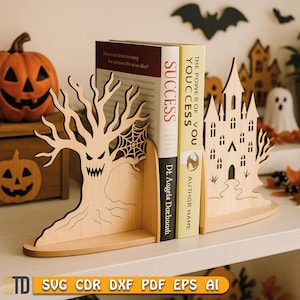 May include: Wooden Halloween-themed bookends. One bookend features a spooky tree with a spiderweb, and the other depicts a haunted castle. Two books are placed between the bookends. The bookends are made of light-colored wood and are on a white shelf.