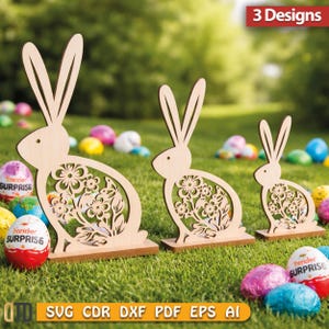 May include: Three wooden Easter bunny decorations with floral cutouts. The bunnies are in different sizes and stand on a grassy lawn with colorful Easter eggs. The image also includes the text "3 Designs" and file type options.
