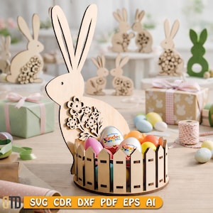 May include: Wooden Easter bunny basket with a fence design, holding colorful eggs. The bunny has a floral cutout design. Other wooden bunny decorations and wrapped gifts are in the background. The image includes the text: SVG CDR DXF PDF EPS AI.