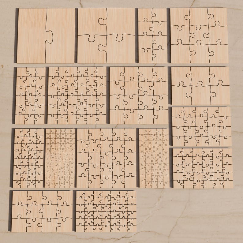 May include: A collection of fifteen light-colored wooden jigsaw puzzles of varying sizes and piece counts, arranged in a grid. Each puzzle features a distinct layout of interlocking pieces with dark, laser-cut lines visible on the smooth surface.