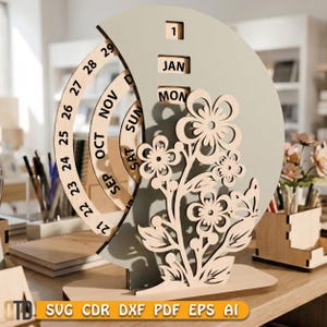 May include: A wooden perpetual calendar with a floral design. The calendar features a light green crescent-shaped background with cut-out flowers and a rotating ring for the days of the month. The date is set to January 1st.