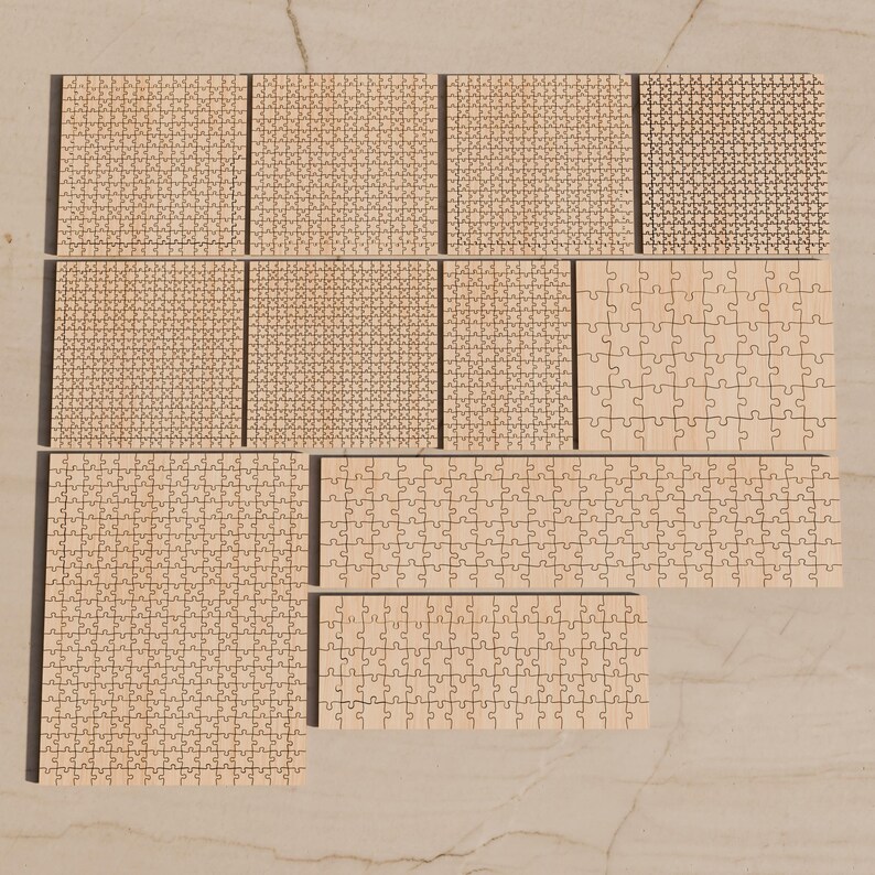 May include: A collection of ten light-colored wooden jigsaw puzzles of varying sizes and piece counts, arranged in a grid-like formation. The puzzles feature natural wood grain textures and interlocking puzzle piece shapes.