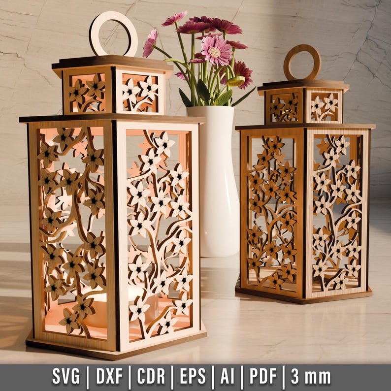 May include: Wooden lanterns with floral cutouts. The lanterns are in various sizes and feature intricate designs of flowers and branches. The lanterns have a warm, inviting glow, and are displayed with a vase of pink flowers. The bottom of the image shows the file formats.