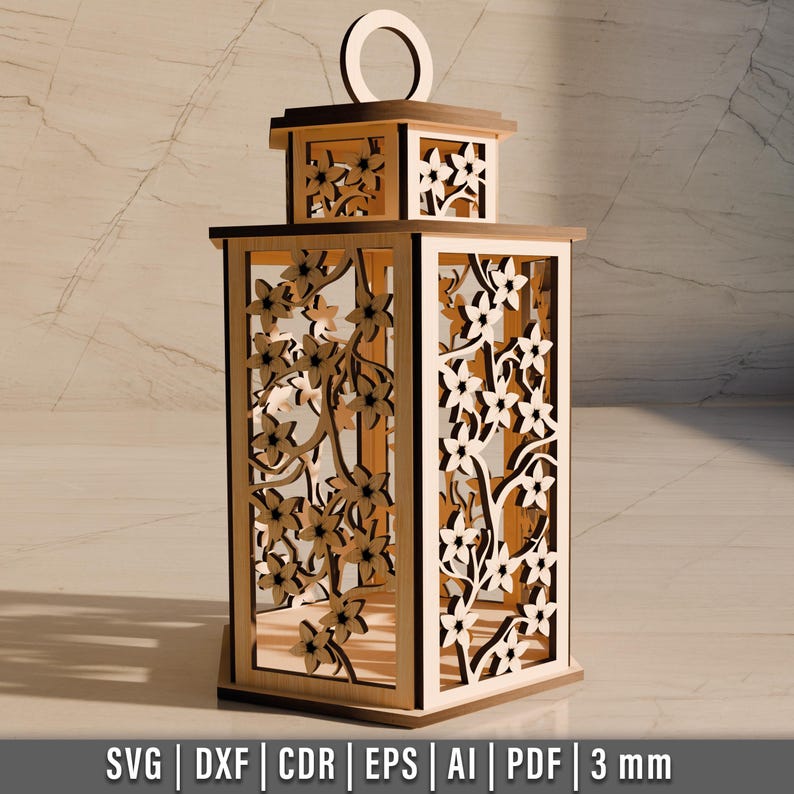 May include: A wooden lantern with intricate floral cutouts. The lantern has a rectangular shape with a handle on top. The design features detailed laser-cut flowers and branches, creating a decorative and elegant look. The bottom of the image shows the file formats: SVG, DXF, CDR, EPS, AI, PDF, and the thickness of the material, 3 mm.