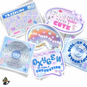 May include: A collection of colorful stickers with various phrases and designs. The stickers feature text like "I'm Feeling Brain Dead", "Crashing Still Cute", and "Oxygen is like a suggestion". The stickers have a pastel color palette with hearts, stars, and bows.