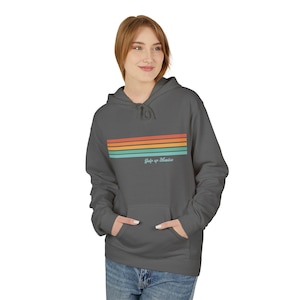 May include: A charcoal gray hoodie with a retro rainbow stripe design and the text "Gulp up Mexico" in a light blue font.
