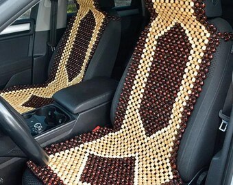 May include: A brown and beige wooden bead car seat cushion. The cushion is made of small, round beads that are woven together in a diamond pattern.