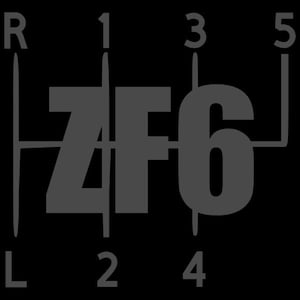 May include: A dark gray graphic of a ZF6 manual transmission shift pattern on a black background. The pattern includes the letters "R" and "L", and the numbers 1, 2, 3, 4, and 5. The letters "ZF6" are prominently displayed.