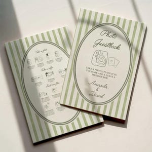 May include: Two photo guestbooks with green and white striped covers. The cover features an oval design with the words "Photo Guestbook" and instructions. The names "Amanda & David" are printed below.
