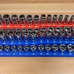 May include: A set of chrome sockets arranged in red and blue organizers. The sockets are various sizes, ranging from 3/8 to 1-1/8 inches. The organizers are labeled with the socket sizes.