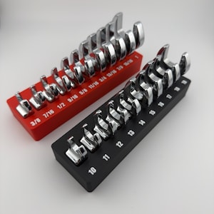 May include: Two sets of chrome wrenches displayed on red and black holders. The red holder has sizes from 3/8 to 15/16 inches. The black holder has sizes from 10 to 19. The wrenches are arranged in size order.