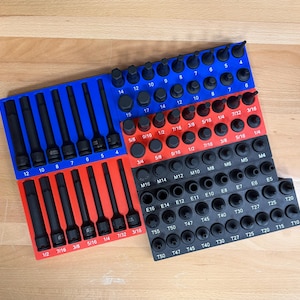 May include: A set of black socket wrenches and bits organized in blue, red, and black trays. The tools are arranged by size and type, with measurements in inches and fractions.