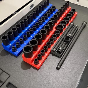 May include: A set of socket wrenches organized in a red and blue tray. The sockets are arranged in size order, with the smallest sockets on the left and the largest sockets on the right. The tray is labeled with the sizes of the sockets. There are also two long black extension bars.