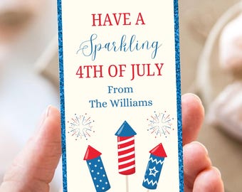 May include: A rectangular card with a blue glitter border and the text "HAVE A Sparkling 4TH OF JULY From The Williams." The card features illustrations of fireworks in red, white, and blue.