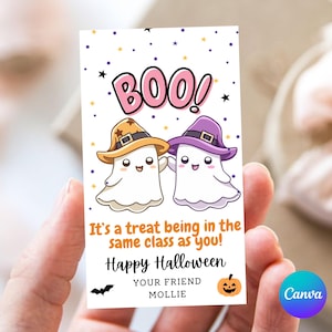 May include: A Halloween-themed card featuring two cartoon ghosts wearing hats, with the word "BOO!" above them. The card includes the text "It's a treat being in the same class as you! Happy Halloween" and is signed "YOUR FRIEND MOLLIE."
