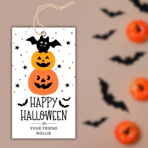 May include: A Halloween gift tag with a string. The tag features a stack of two orange jack-o'-lanterns topped with a black bat. The words "HAPPY HALLOWEEN" are printed below, with "YOUR FRIEND MOLLIE" at the bottom.