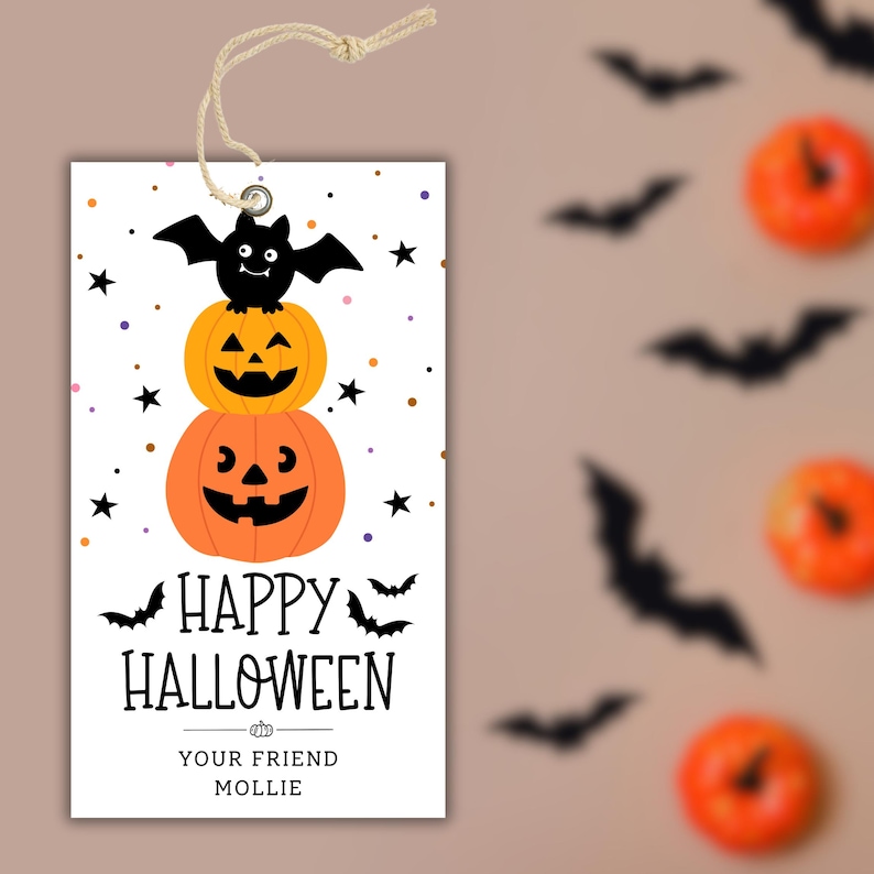 May include: A Halloween gift tag with a string. The tag features a stack of two orange jack-o'-lanterns topped with a black bat. The words "HAPPY HALLOWEEN" are printed below, with "YOUR FRIEND MOLLIE" at the bottom.