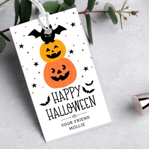 May include: A white Halloween gift tag with a stacked pumpkin design, a black bat, and the words "Happy Halloween." The tag includes the text "Your Friend Mollie."