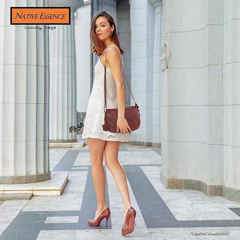 May include: A dark red woven leather crossbody bag with a long shoulder strap and a small hanging tassel detail. The bag features a textured surface and is worn over a white sleeveless dress paired with matching dark red high-heeled pumps.