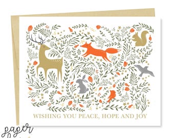 May include: A rectangular greeting card featuring a white background with a forest scene of a tan deer, an orange fox, a gray rabbit, a squirrel, and a bird amidst green foliage and orange flowers. The text reads WISHING YOU PEACE, HOPE AND JOY.