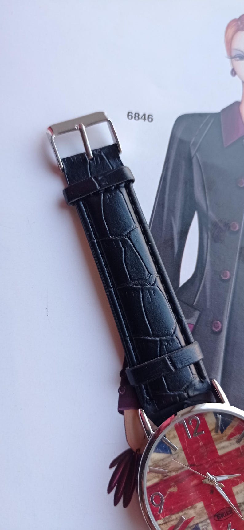 New wristwatch featuring the Union Jack (British flag) on the dial, with a black faux leather strap and silver buckle. Unused quartz timepiece, stylish and perfect for fans of British culture or punk fashion.