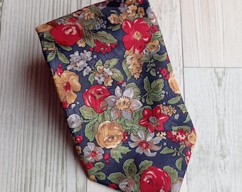 May include: A navy blue necktie with a floral pattern featuring red roses, yellow and white flowers, and green leaves. The tie is made of a smooth fabric and has a classic shape, suitable for formal or semi-formal occasions.