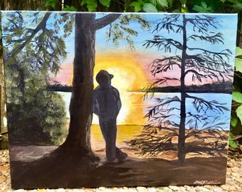 Lakeside painting quiet morning sun rising over water man leaning against tree taking in the view of sun glistening on lake